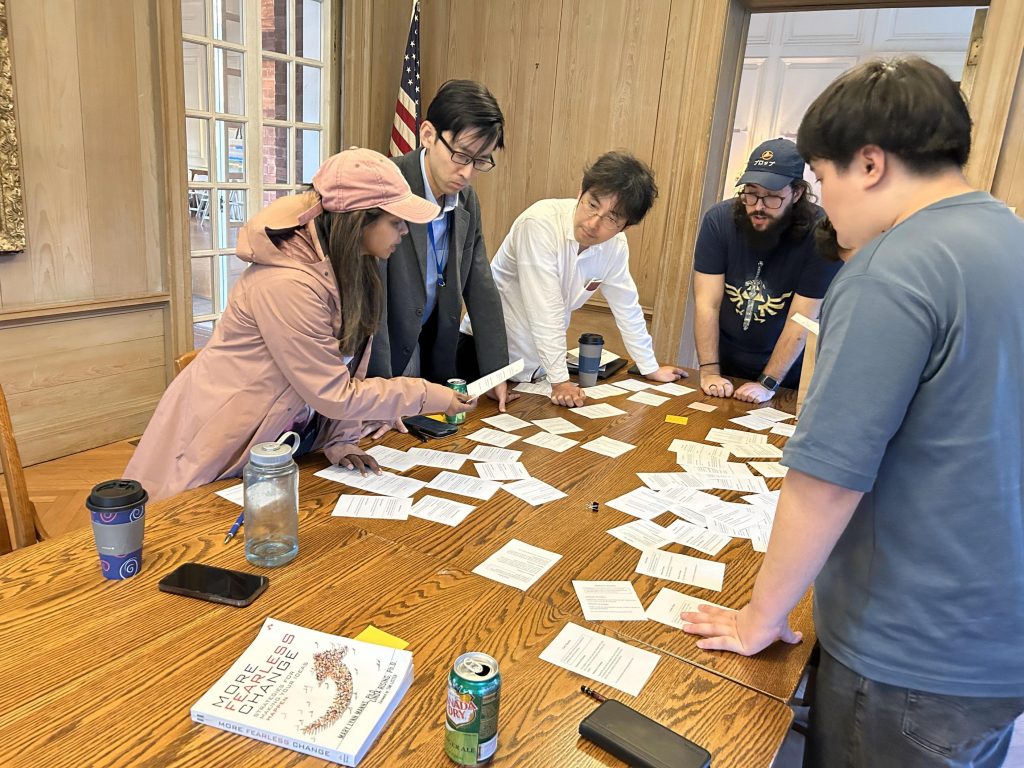 Group of people discussing cards on a table during a focus group session